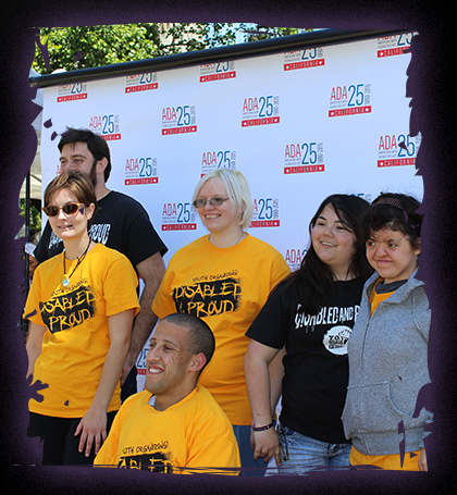 Photo of a YO! youth group posing in front of an ADA celebration banner.